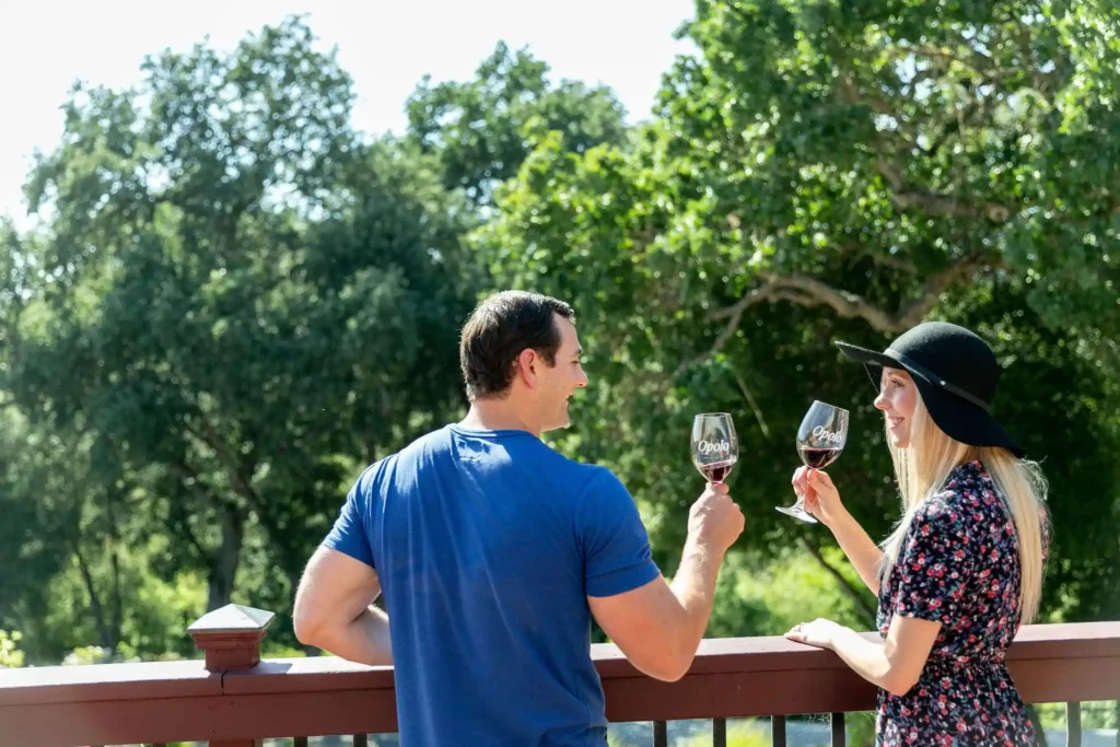 Man and woman sharing a glass of Opolo wine on a beautiful day