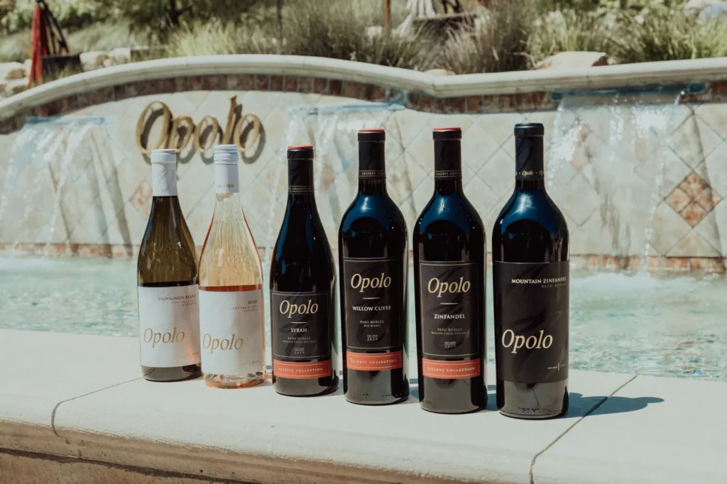 Lineup of Opolo wine bottles in front of a fountain
